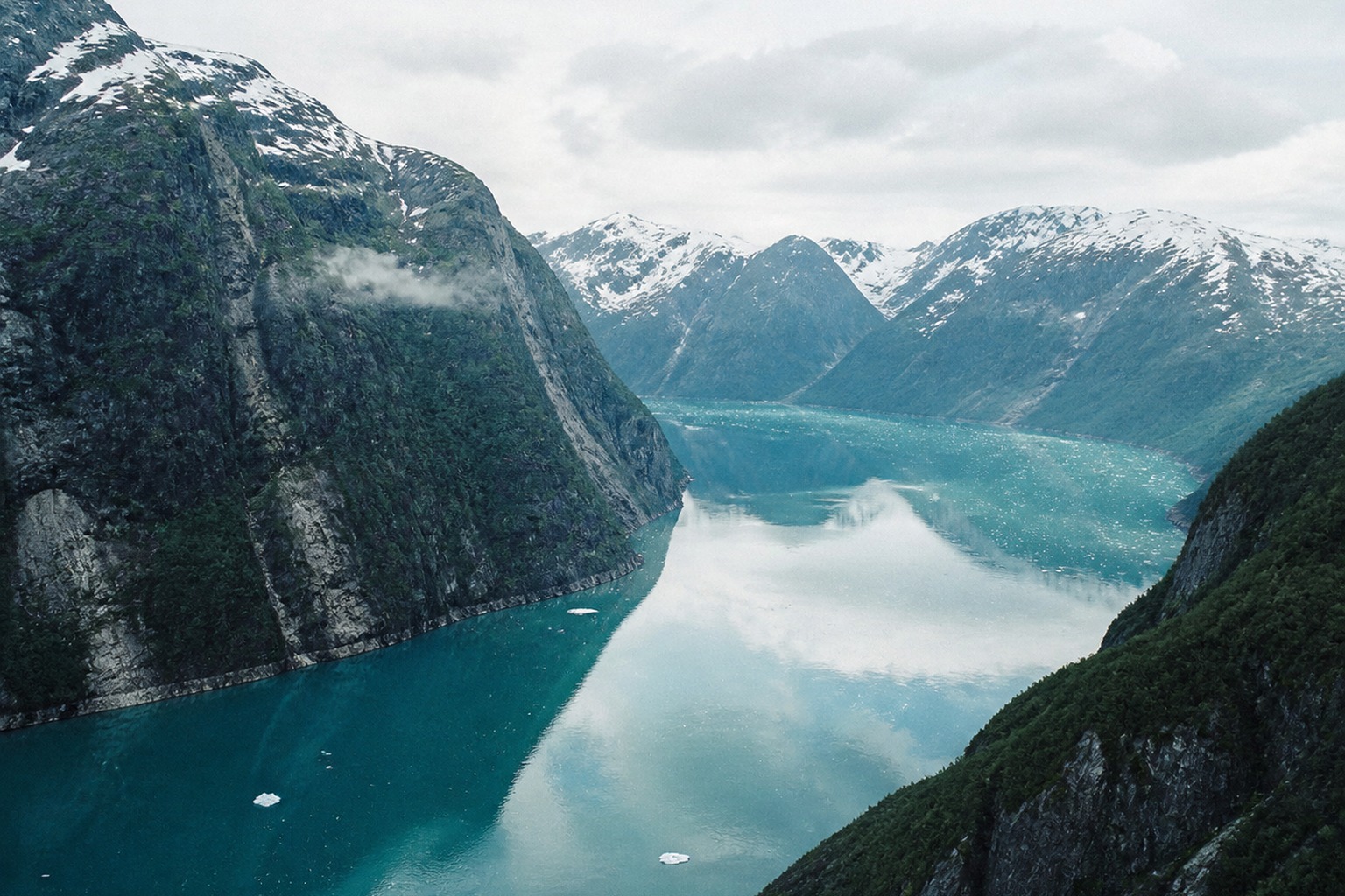 Steep mountains entering icy water in the high north